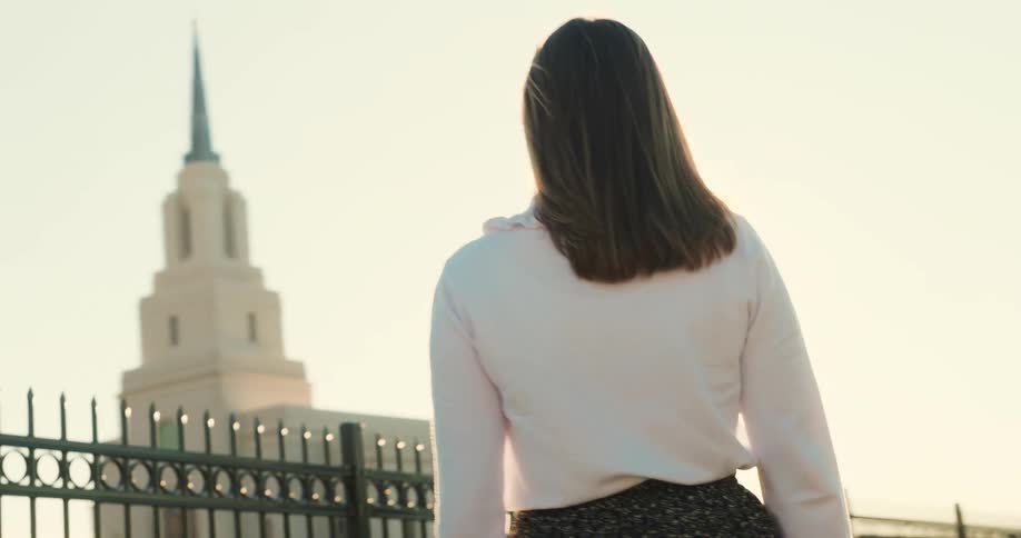 Girl from behind illuminated by the sun