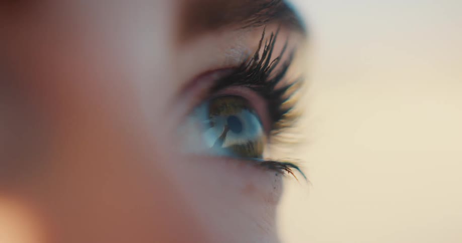 A persons eye capturing the intricate details of their eyelashes and the subtle reflections in their iris