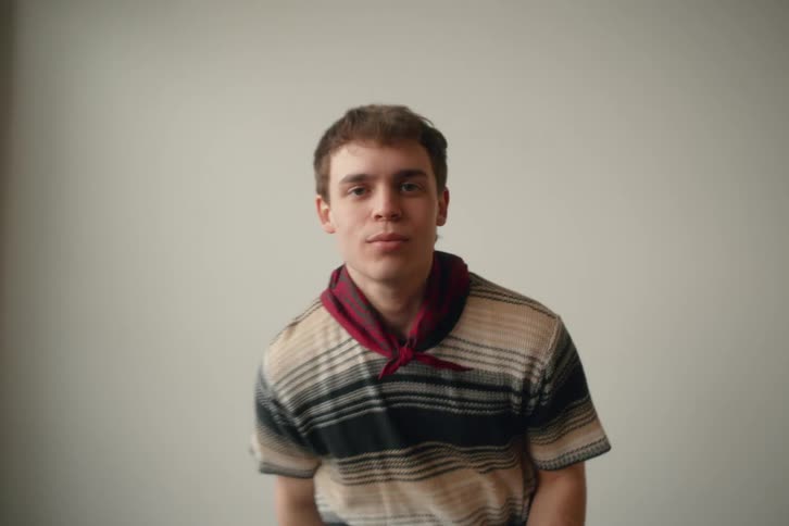 An indoor footage of a boy sitting