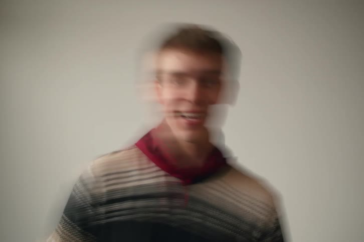 A model smiles while moving back and forth
