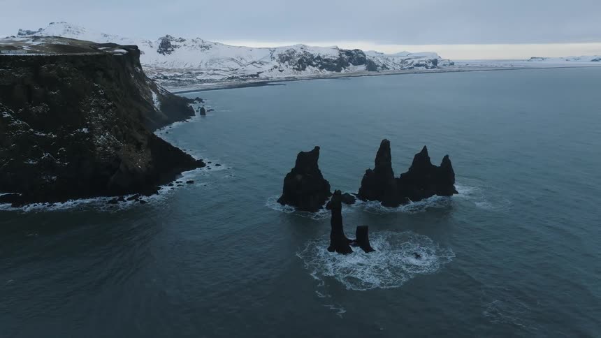 The coast is lined with snow covered mountains