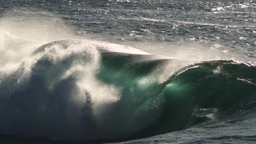 Wave forming in slow motion and crashing in the ocean