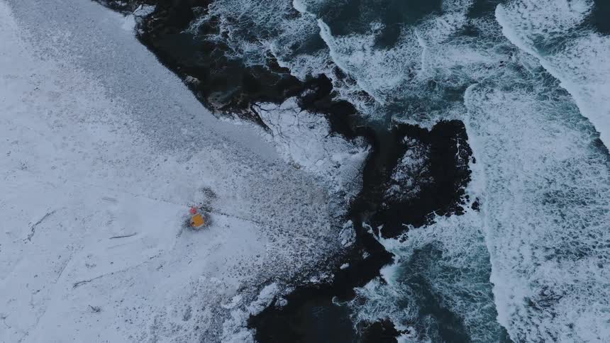 Waves crashing on a snowcovered coast