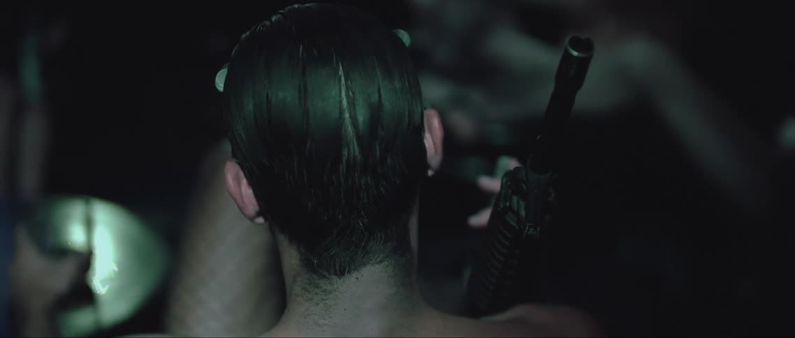 A person is sitting with a drink and rifle