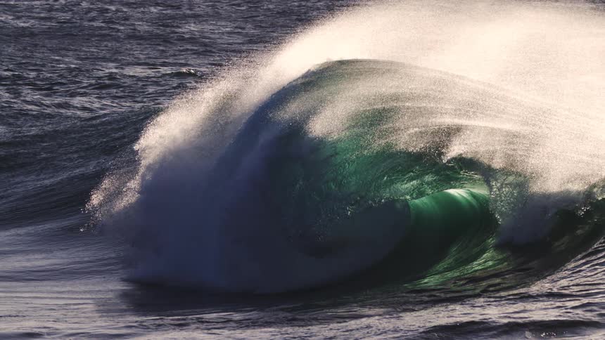 Wave forming in slow motion and crashing in the ocean