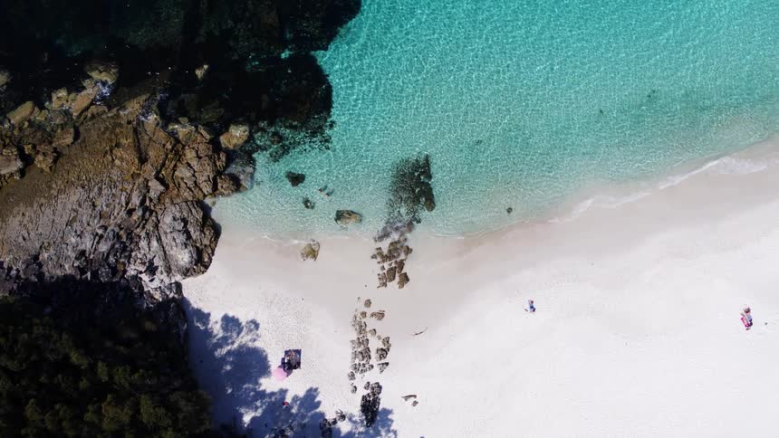 Blue water is on the beach sands