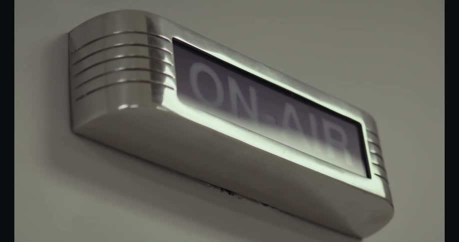 Flashing onair sign from metal box indicating recording in broadcasting studio