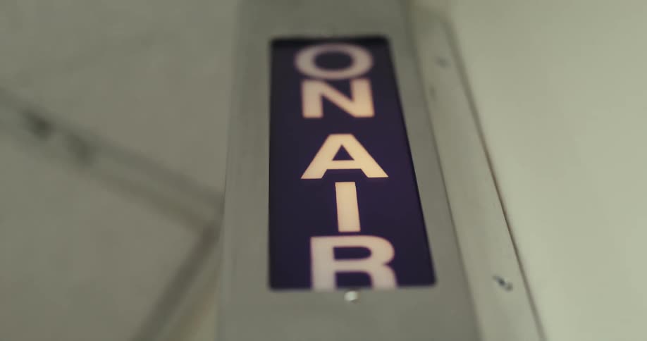 The on air sign is flashing in the radio station