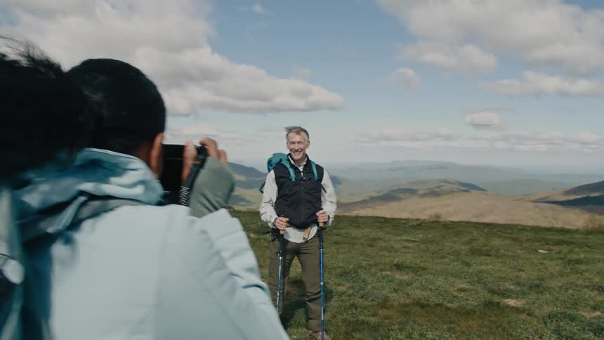 A footage of a lady taking a picture of a man