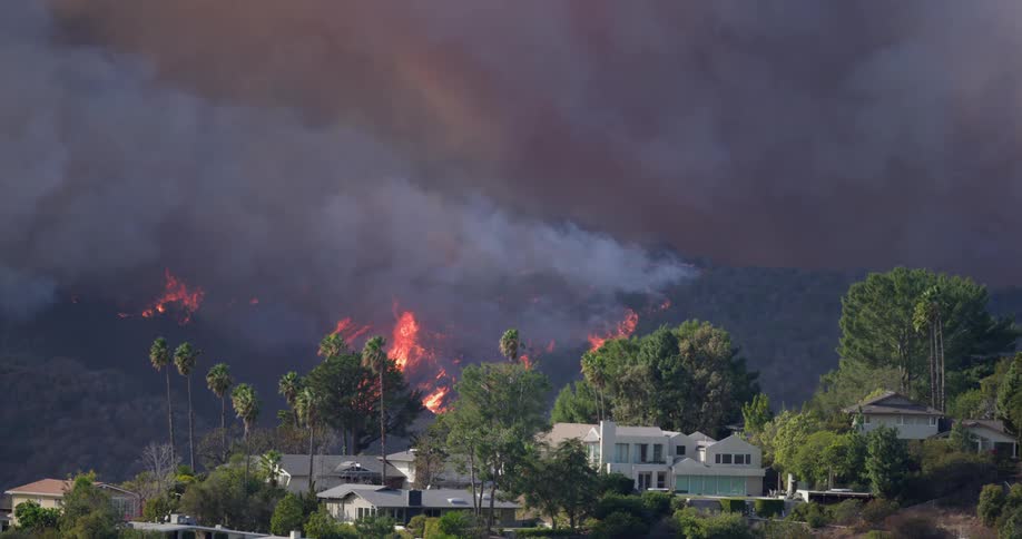Wild fire burning in the hills behind neighboring residential community