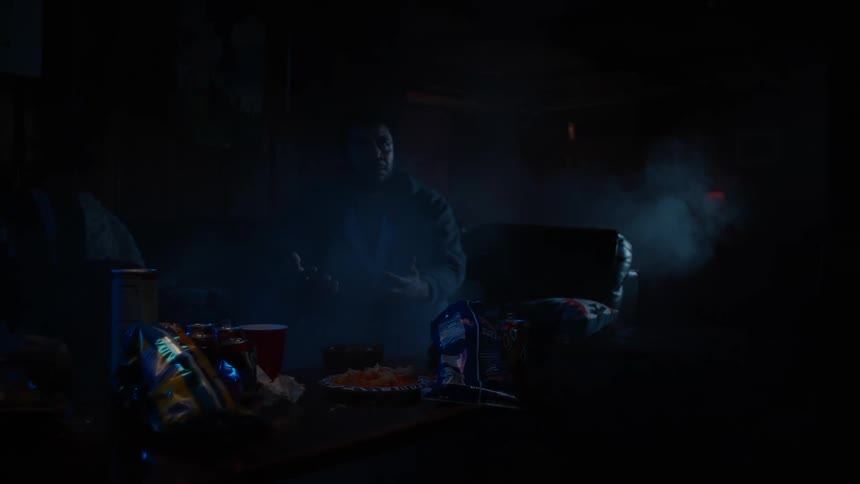 Smoke begins filling the room while a man plays video games