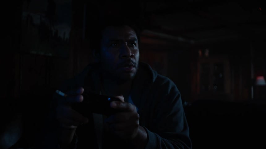 A person is playing video games by himself at night