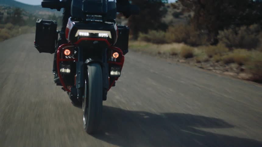 A person is riding his motorcycle on a small trail