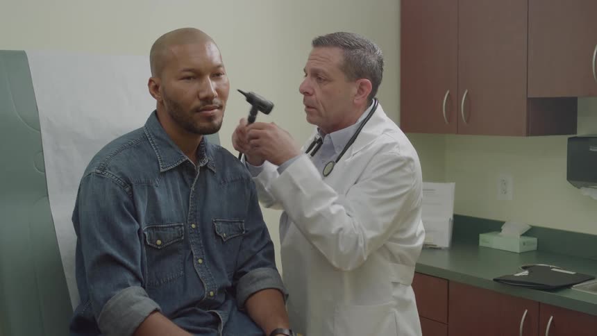 A doctor is examining a patient