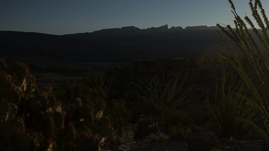 Time lapse of a rural area in the wild with plants and mountains