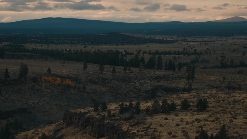 Aerial view of high plains and wood covered hills on a cloudy morning