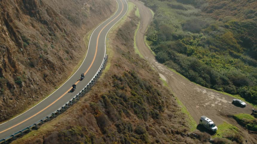 A footage of people riding a bike in the mountains
