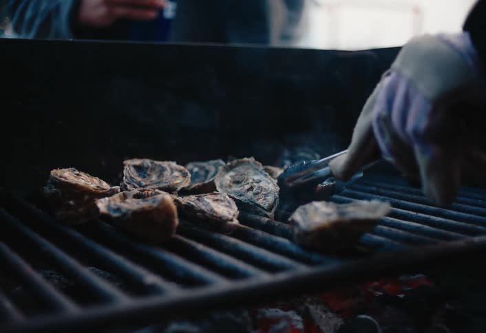 A close up clip of a person making a barbecue