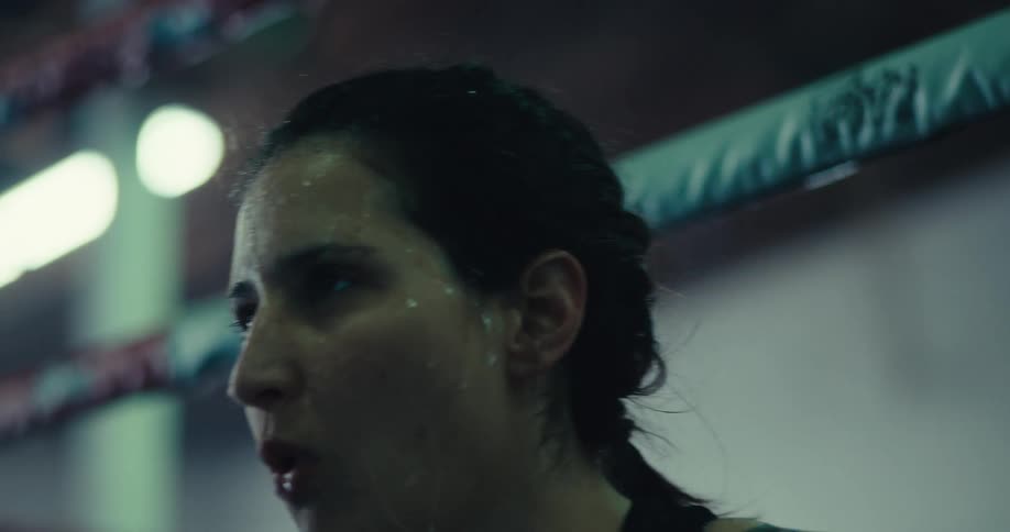 Woman pouring water on her face