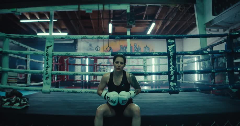 A female athlete is getting ready for a boxing competition