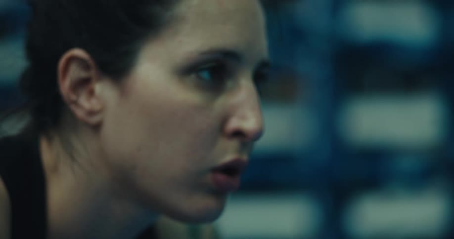 A woman is resting after an intense workout at the gym