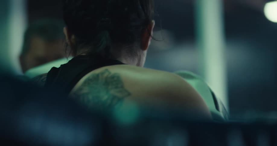 A man is helping a woman train for a boxing match