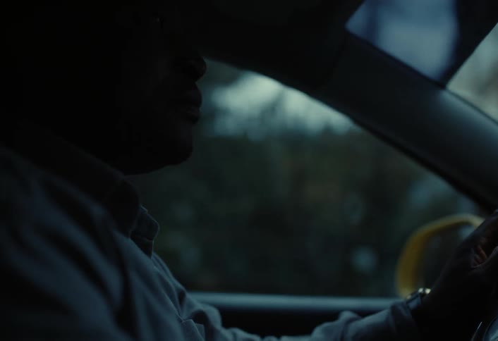 A close up clip of a man driving