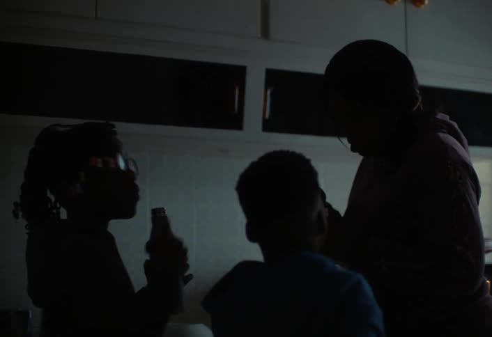 A footage of siblings having a drink in the kitchen