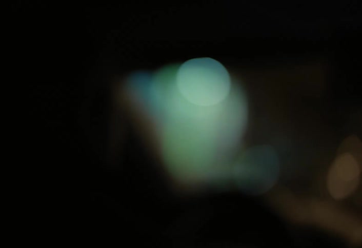 Person drives a vehicle through the city at night