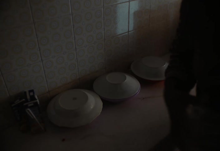 A man unpacks items in the kitchen