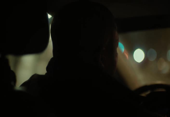 View of a street from the inside view of a car