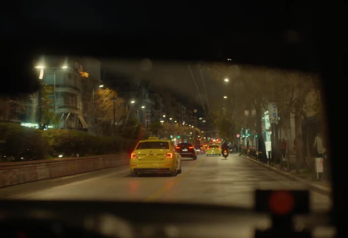 A man drives past the taxi in traffic