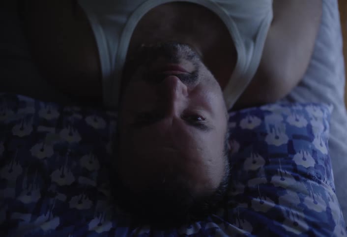 A man is resting in bed