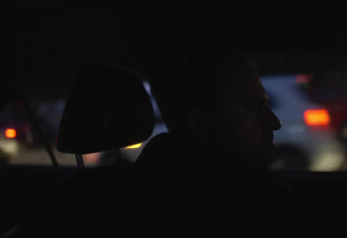 Man in the dark driving a car