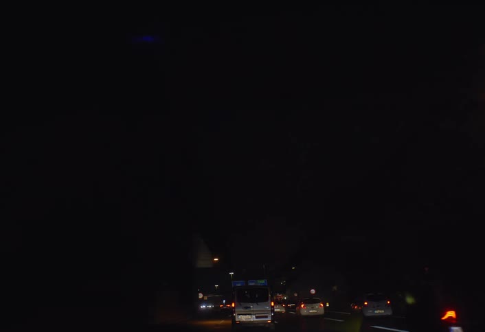 Cars are driving on a highway during the night time