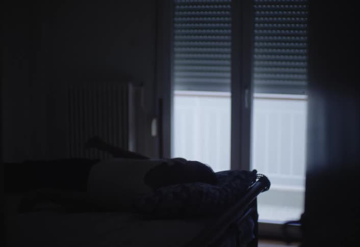 A man tosses and turns in bed