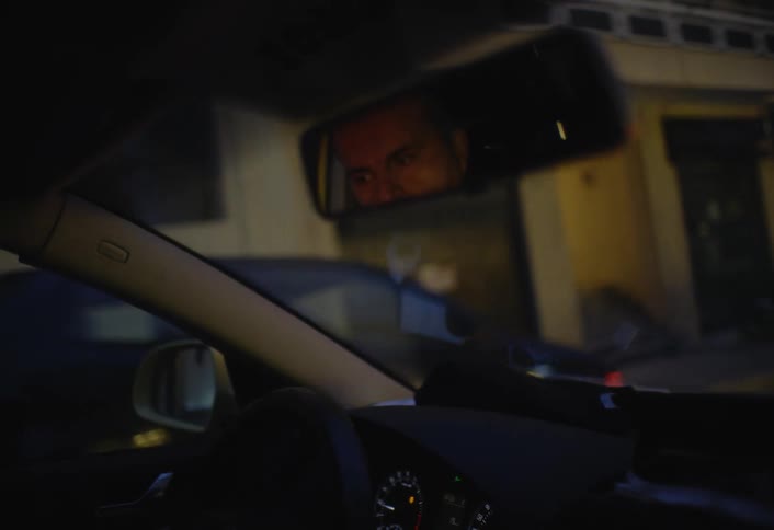 A man turns the corner in his car