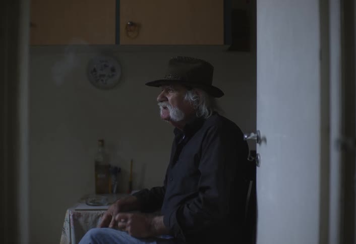A footage of an old man having a smoke