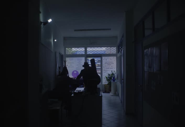 A man enters the shop with his guitar