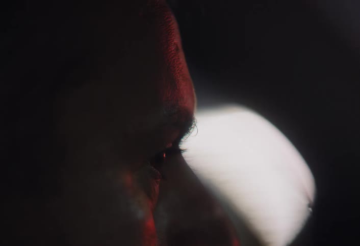 A man is driving at night and looking around