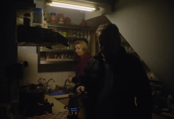 A man is boiling water in the kitchen