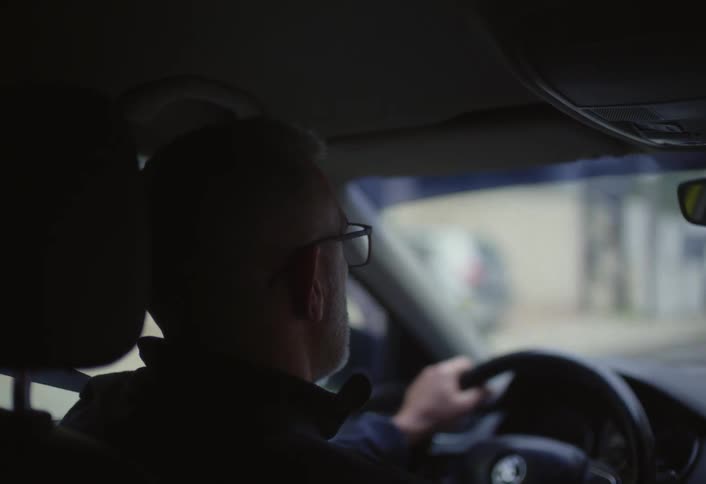 Cars pass the man driving in traffic
