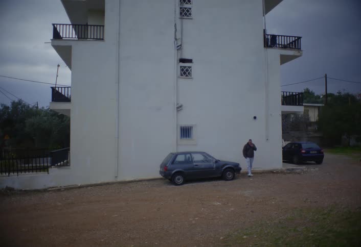 A footage of a man walking round a neighborhood