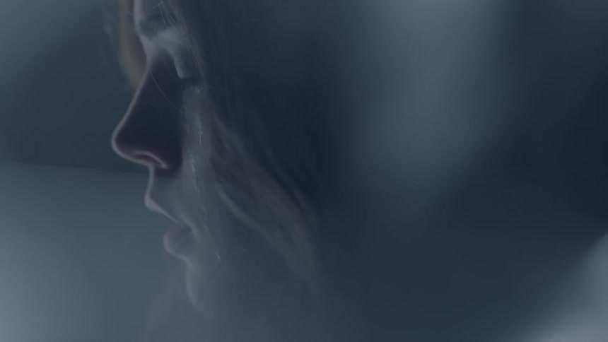 A woman has tears running down her face