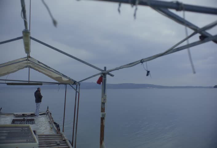 A footage of a man standing at the seashore