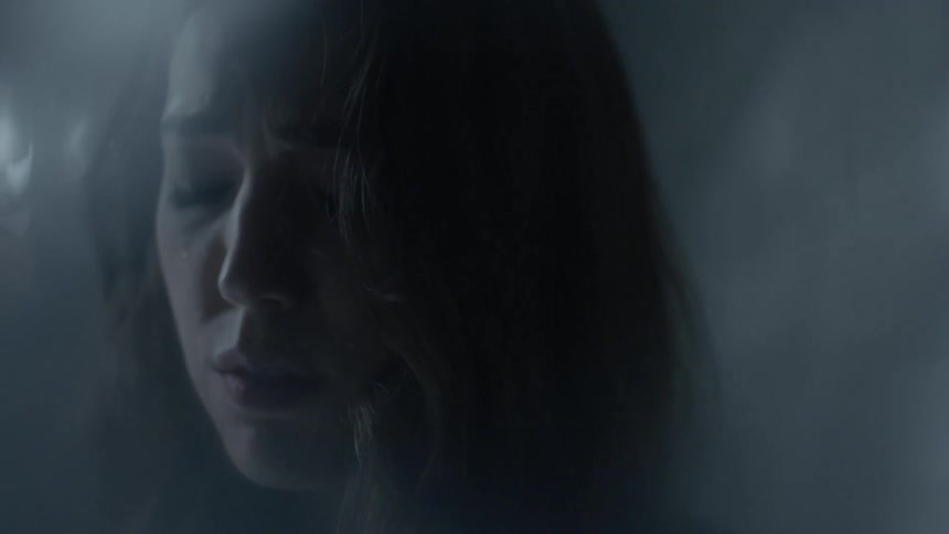 A woman cries with her eyes closed