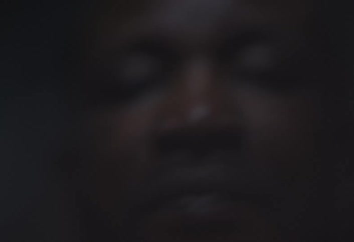 A man wipes his face with hands