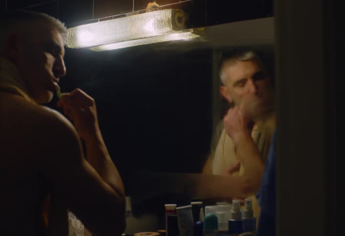 A footage of a man brushing his teeth