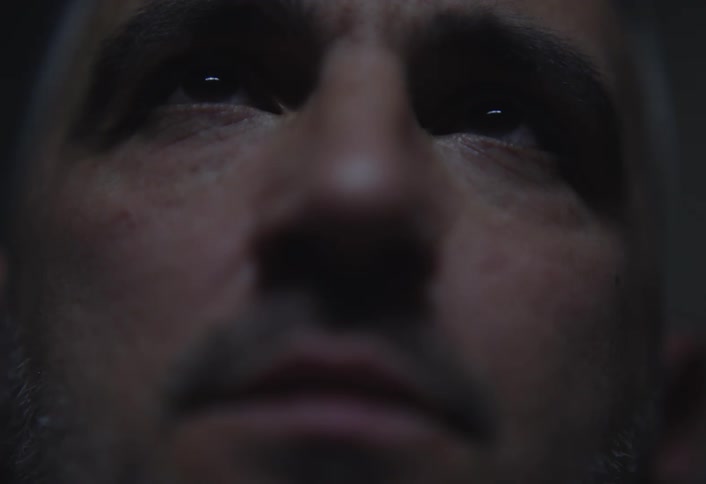 A mans eyes looking upwards with a slightly blurry quality and a dark moody tone
