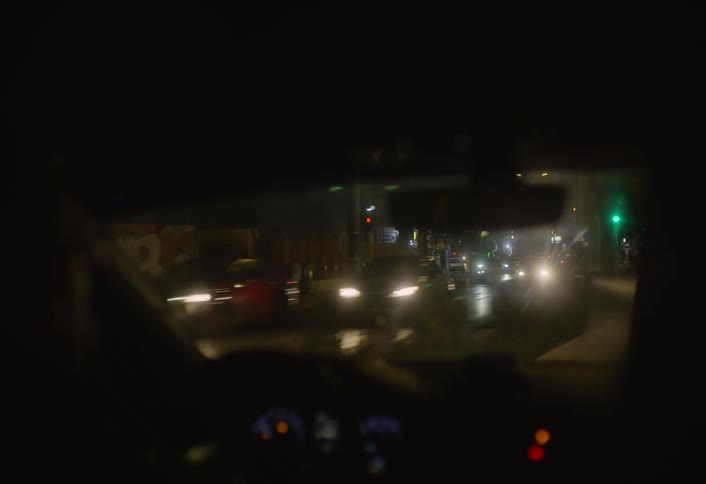 The car passes the shops on the road